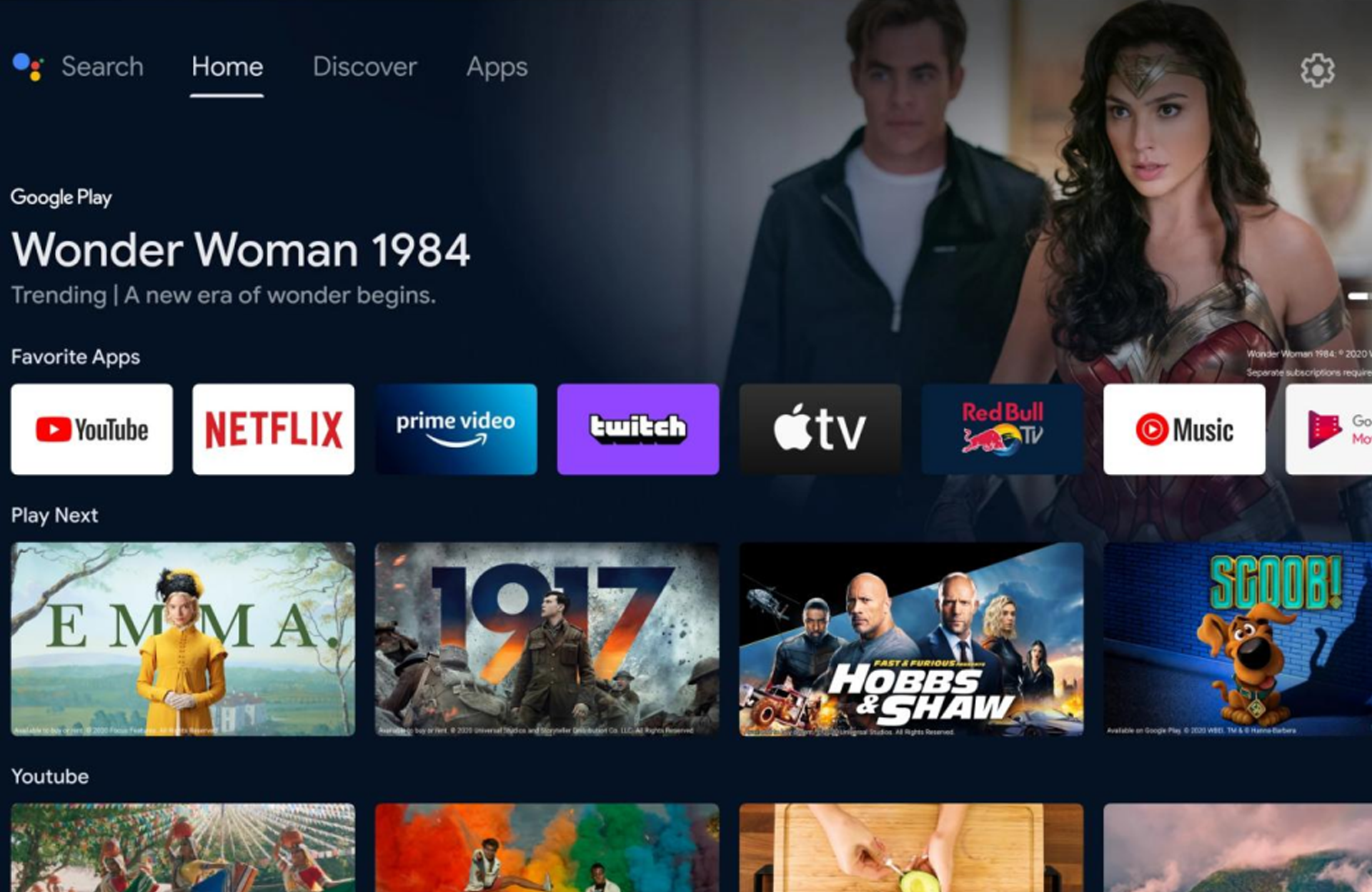 Android TV interface of Wanbo projector—showcasing "Wonder Woman 1984" as trending, with favorite apps like YouTube, Netflix, Prime Video, Twitch, Apple TV, etc., and various movie & video thumbnails